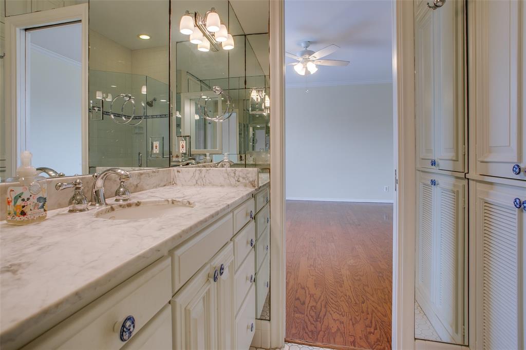 6314 Bandera Avenue, Unit C Dallas, TX 75225 - Photo 30 of 40 a bathroom with a granite countertop sink a large mirror and a shower