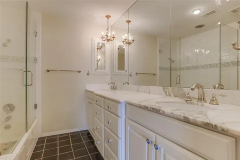 a bathroom with a granite countertop sink a shower and a mirror