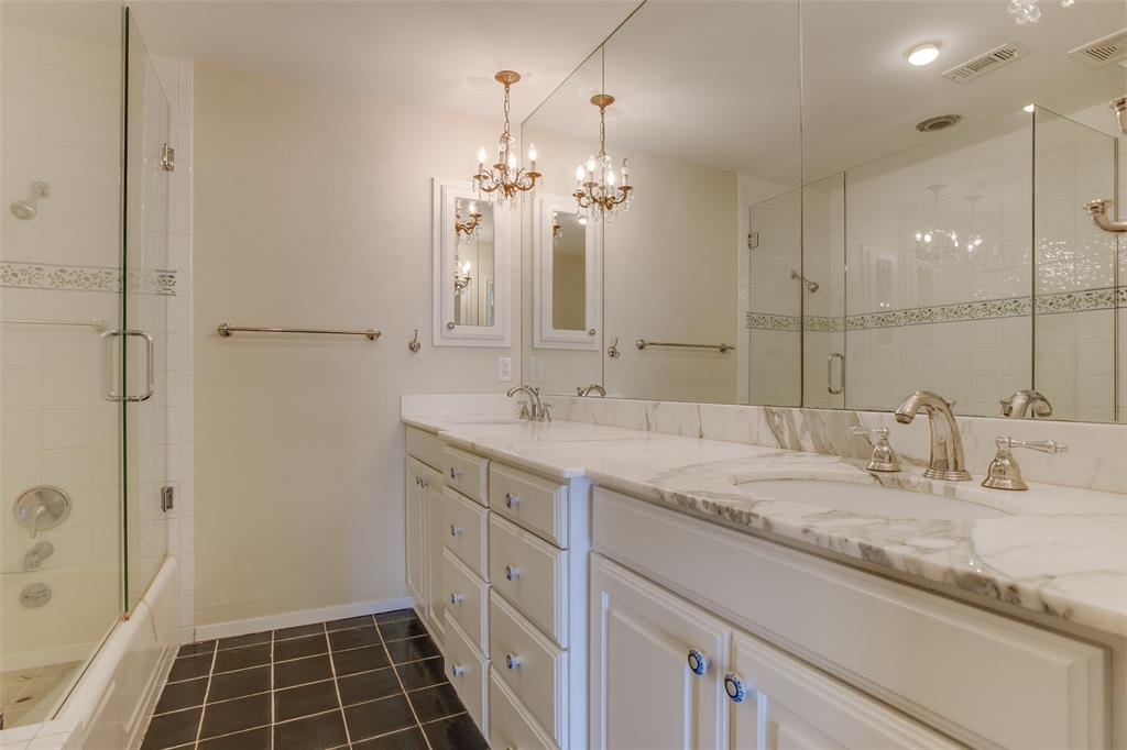 6314 Bandera Avenue, Unit C Dallas, TX 75225 - Photo 35 of 40 a bathroom with a granite countertop sink a shower and a mirror