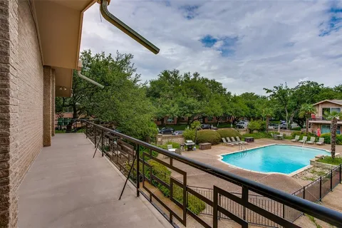 a view of a swimming pool with a patio