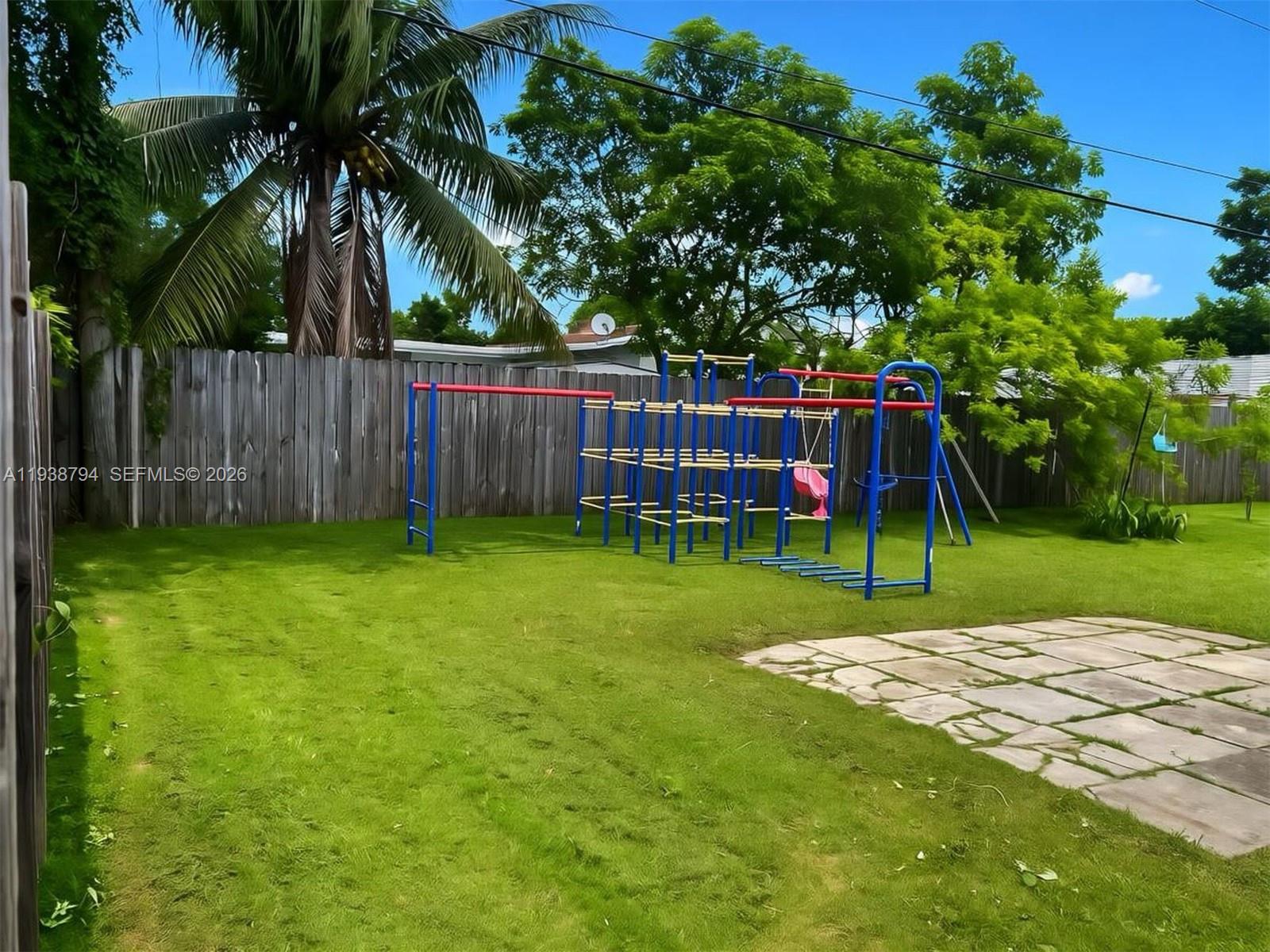 9955 Southwest 214th Street Cutler Bay, FL 33189 - Photo 12 of 15 a view of a backyard with a slide trees