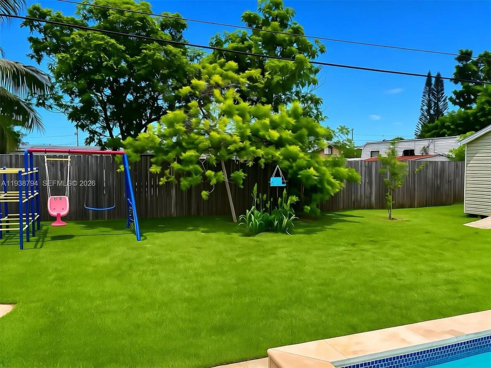 9955 Southwest 214th Street Cutler Bay, FL 33189 - Photo 13 of 15 a view of a backyard with a garden and entertaining space