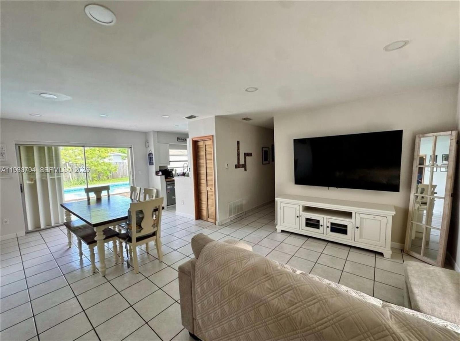 9955 Southwest 214th Street Cutler Bay, FL 33189 - Photo 4 of 15 a living room with furniture and a flat screen tv