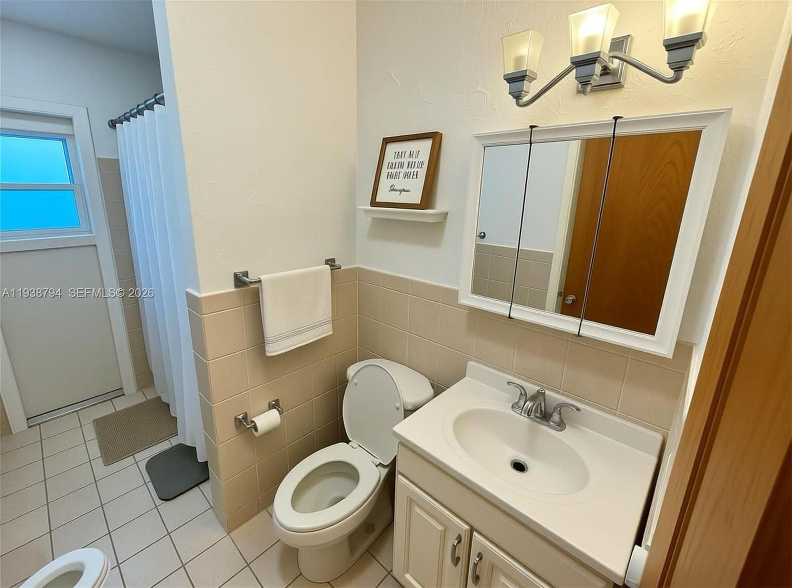 9955 Southwest 214th Street Cutler Bay, FL 33189 - Photo 6 of 15 a bathroom with a sink toilet and shower