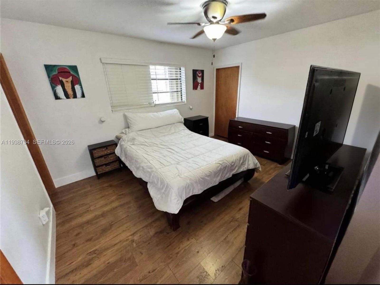 9955 Southwest 214th Street Cutler Bay, FL 33189 - Photo 7 of 15 a bedroom with a bed and a flat screen tv