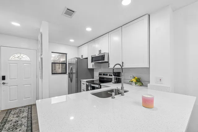 a living room with furniture flowerpot and wooden floor