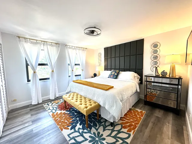 a view of a hallway with stairs and wooden floor