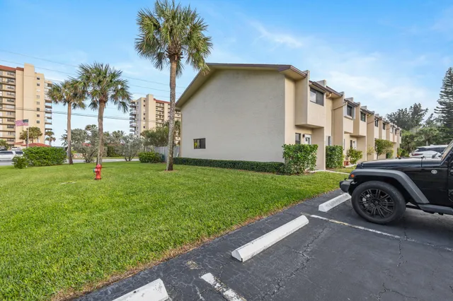a view of a street with a lawn chairs and a table
