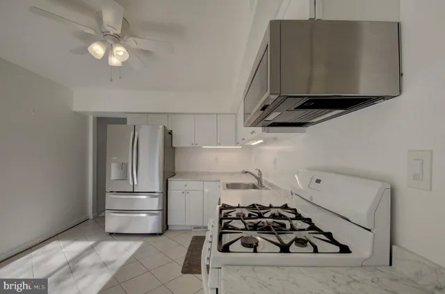 a kitchen with a stove and a refrigerator