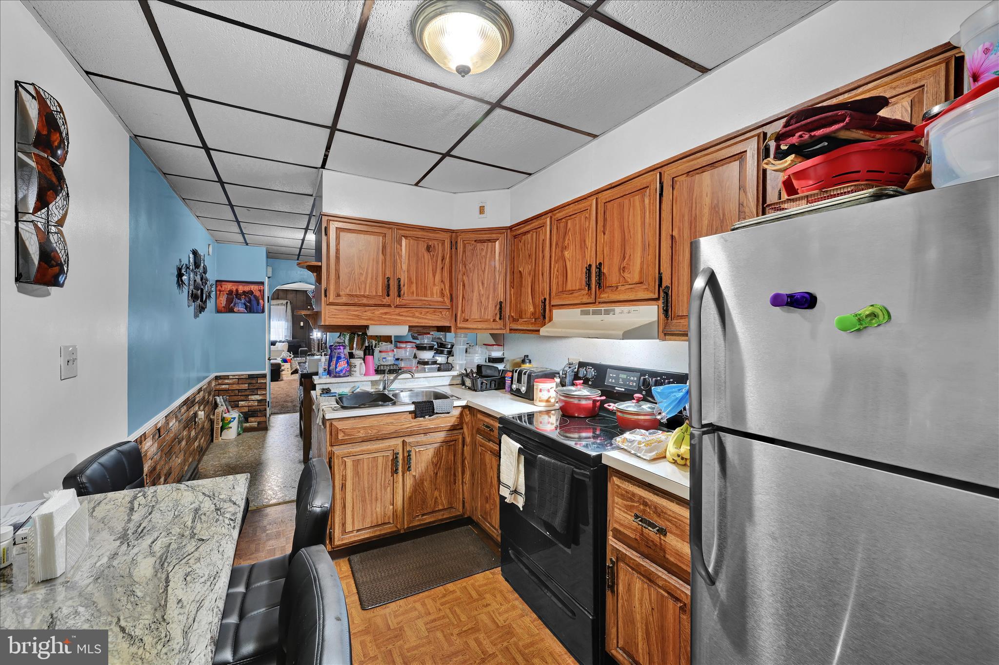 936 Pike Street Reading, PA 19604 - Photo 14 of 24 a kitchen with a refrigerator a stove a microwave and cabinets