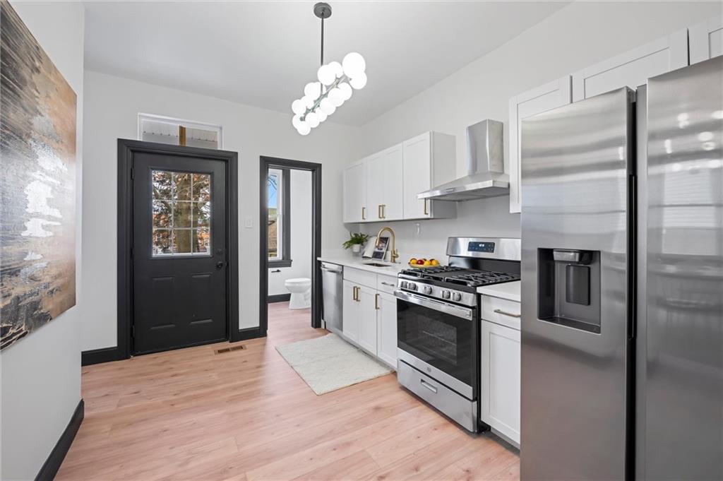 8 Marie Avenue Avalon, PA 15202 - Photo 14 of 48 a kitchen with stainless steel appliances granite countertop a refrigerator and a stove top oven