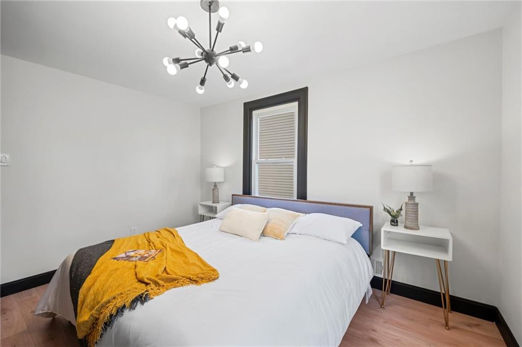 8 Marie Avenue Avalon, PA 15202 - Photo 24 of 48 a bedroom with a bed and a chandelier