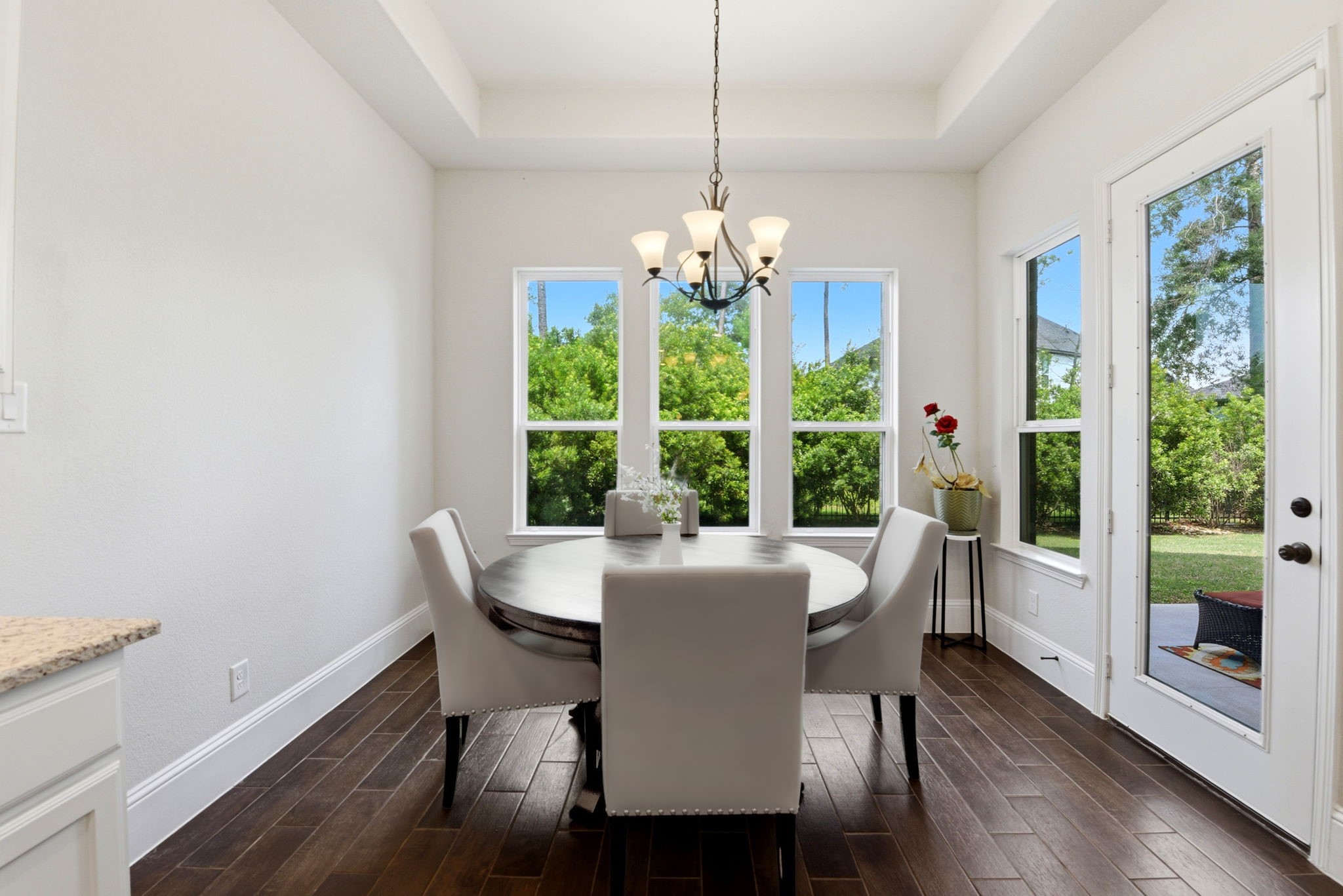 10062 South Goshawk Trail Conroe, TX 77385 - Photo 15 of 43 a dining room with furniture a chandelier and wooden floor
