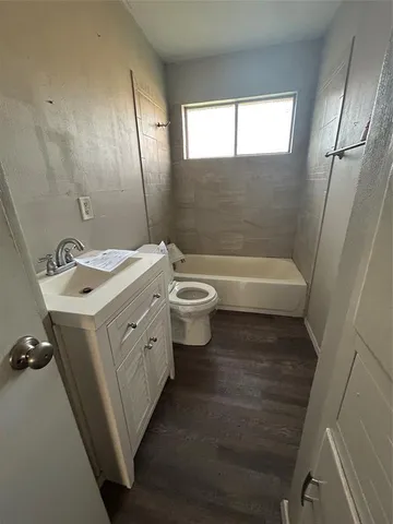 a bathroom with a sink a toilet and tub
