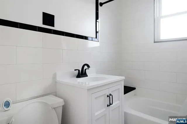 a bathroom with a sink a toilet and a bathtub