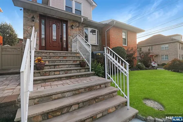a view of a house with a small yard next to a yard