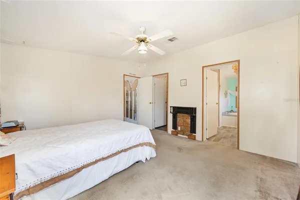 a bedroom with a bed and a fireplace