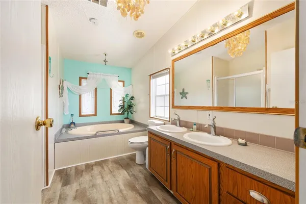 a bathroom with a sink a large mirror and a bathtub