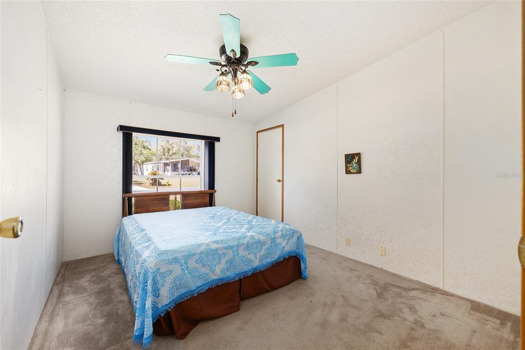 2335 North Loma Point Hernando, FL 34442 - Photo 21 of 47 a bedroom with a bed and a chandelier