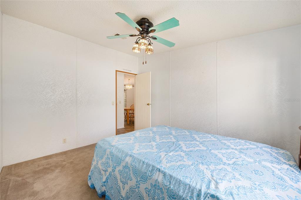 2335 North Loma Point Hernando, FL 34442 - Photo 22 of 47 a bedroom with a bed and a chandelier