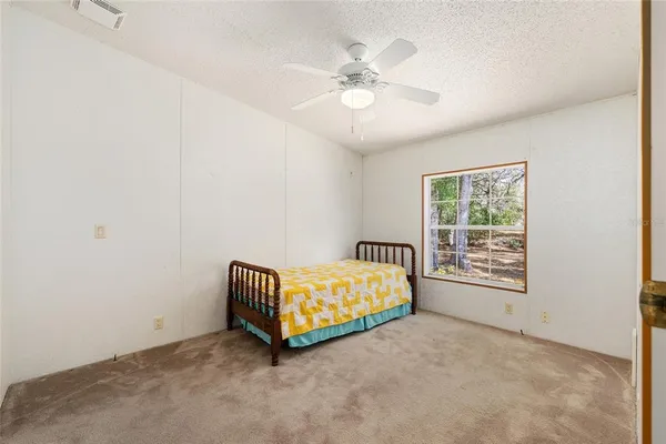a room with a bed and a chandelier