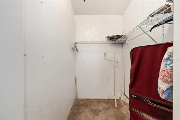 a view of walk in closet with clothes