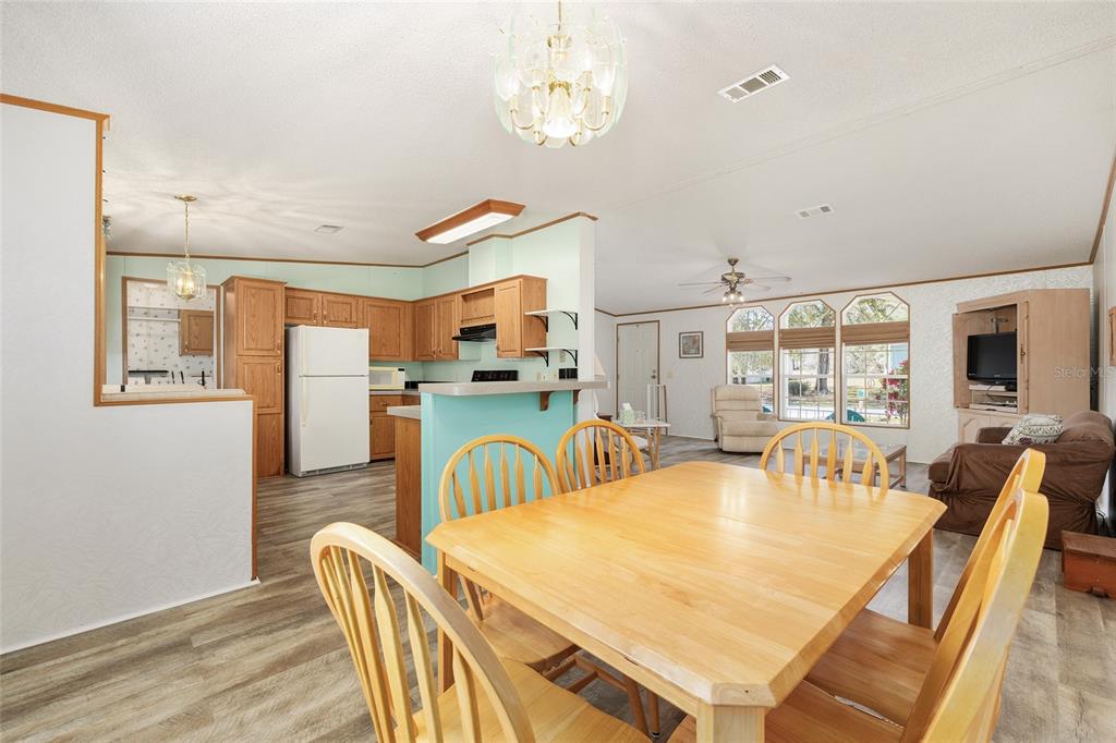 2335 North Loma Point Hernando, FL 34442 - Photo 30 of 47 a dining room with furniture a chandelier and wooden floor