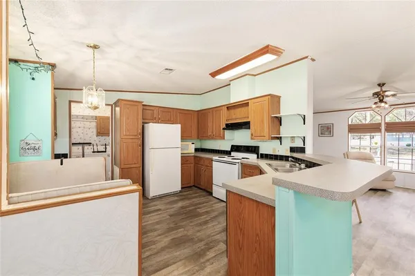 a kitchen with a refrigerator a stove and a sink