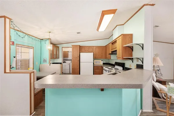 a kitchen with stainless steel appliances granite countertop a sink and a refrigerator