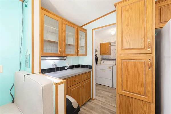 a kitchen with a refrigerator stove and wooden cabinets