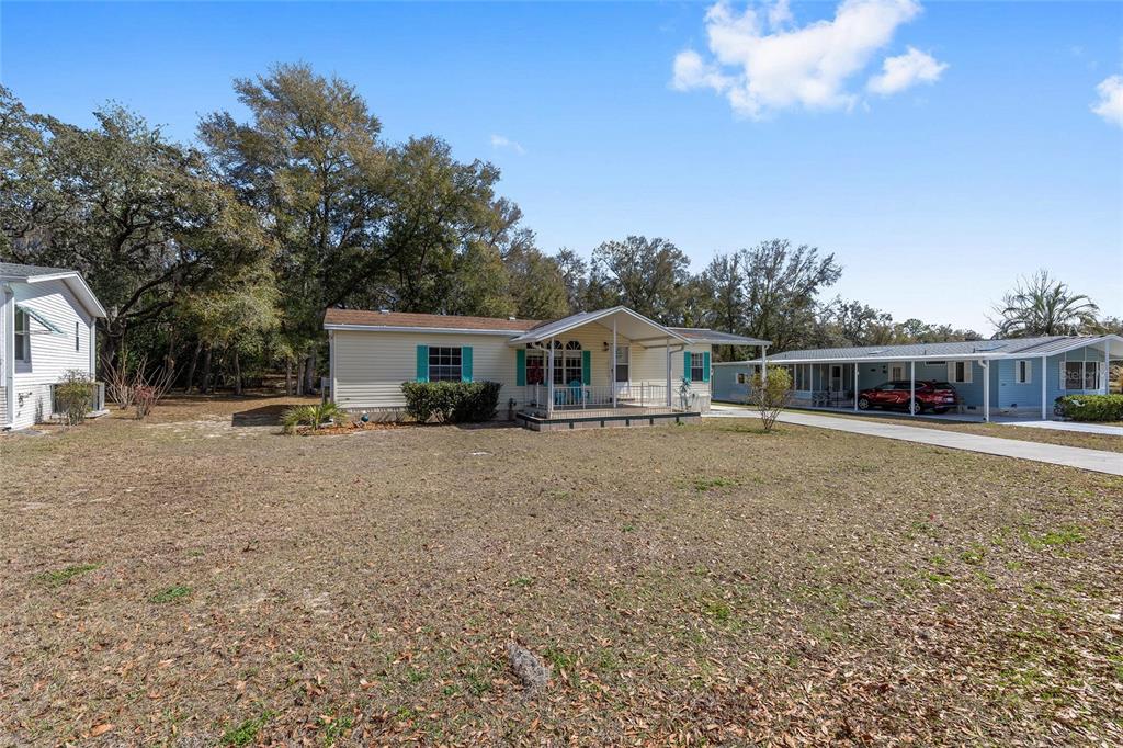 2335 North Loma Point Hernando, FL 34442 - Photo 4 of 47 a front view of a house with a garden