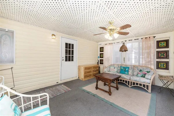 a living room with furniture and white walls
