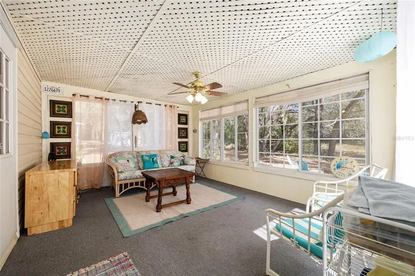 a living room with furniture and large windows