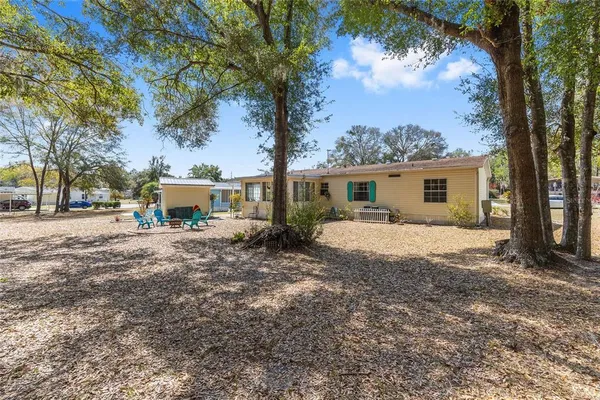 a view of a house with a tree in front of it