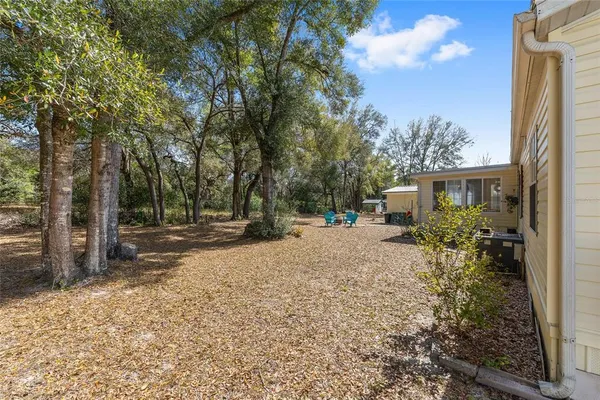 a view of backyard of house with green space