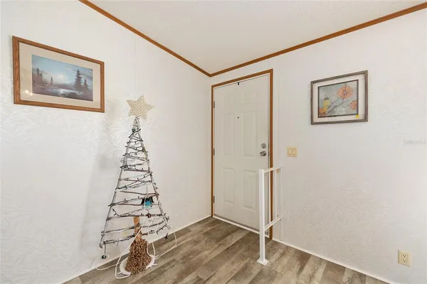 a view of an entryway with wooden floor