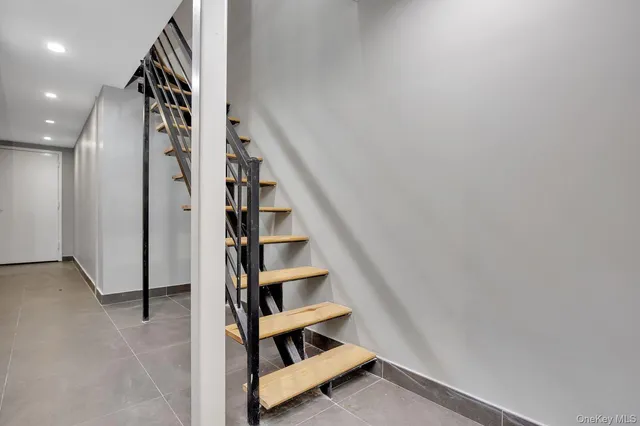 an entryway in a hallway with wooden floor and entryway