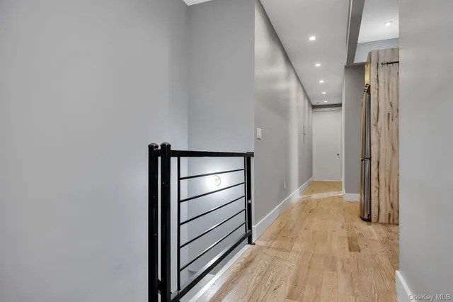 a view of hallway with stairs and wooden floor