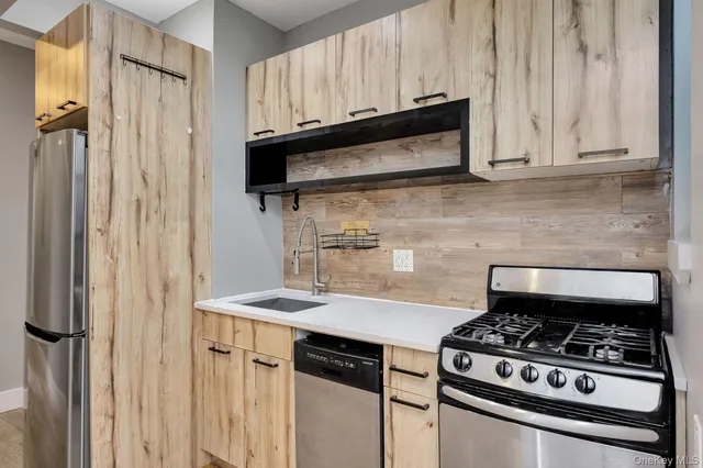 a kitchen with granite countertop a stove and a microwave