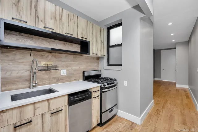 a kitchen with stainless steel appliances granite countertop a sink stove and microwave