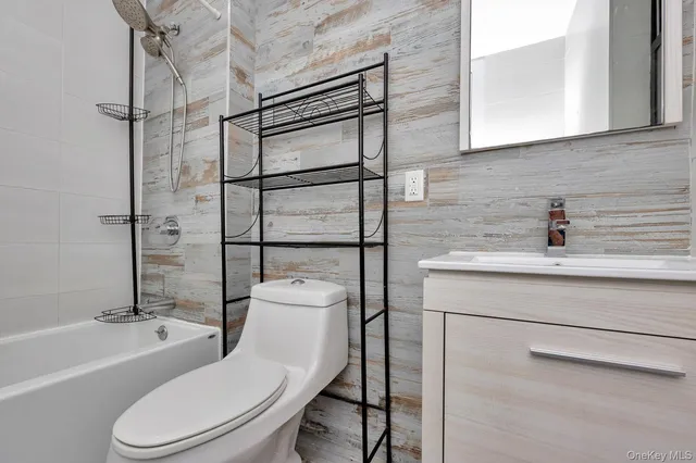 a white toilet sitting next to a bathroom sink