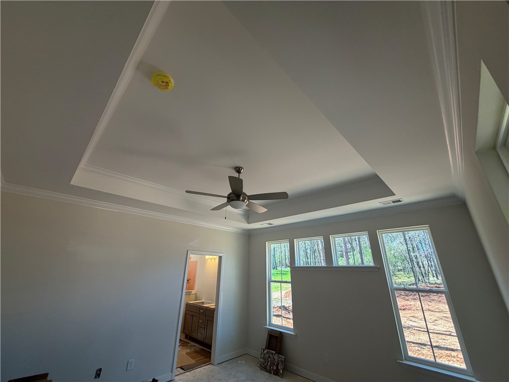 110 Lakeside Drive Anderson, SC 29621 - Photo 6 of 8 This airy room features a high tray ceiling, offering a sense of openness and architectural detail.