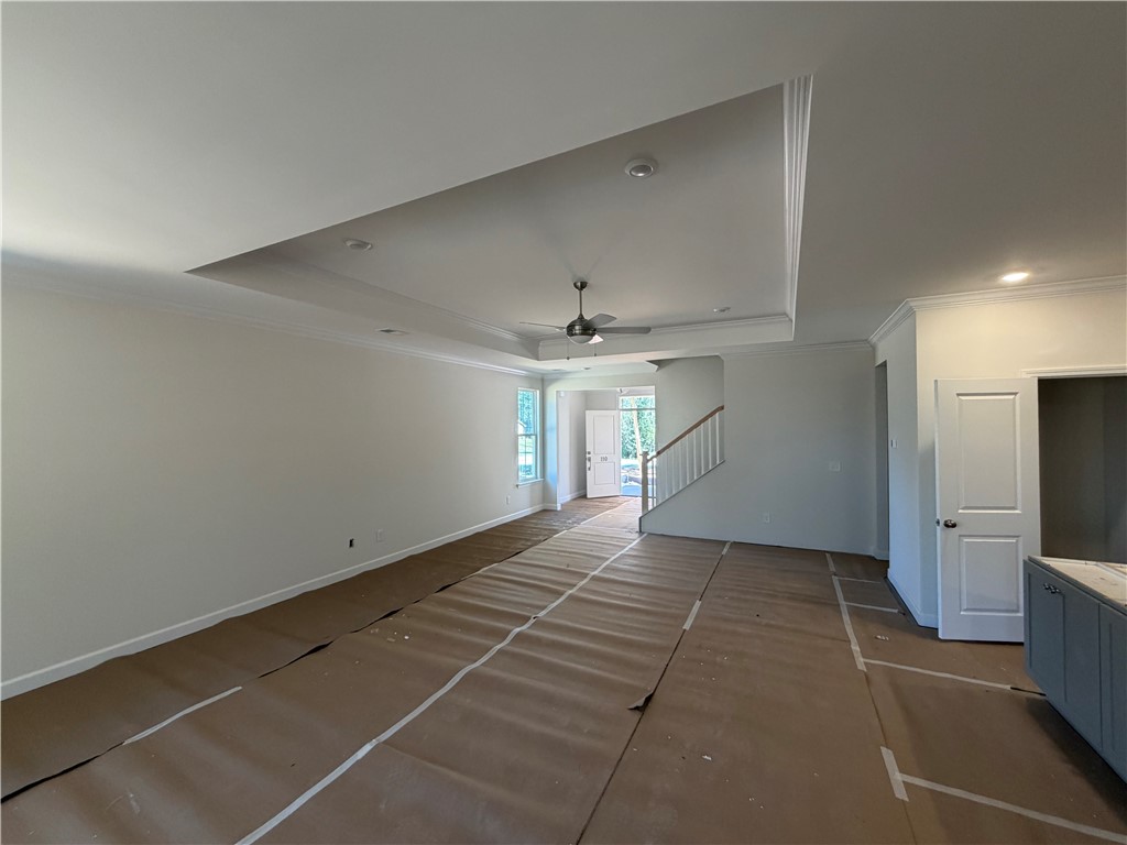 110 Lakeside Drive Anderson, SC 29621 - Photo 7 of 8 This expansive great room features crown molding and a staircase, offering seamless living.