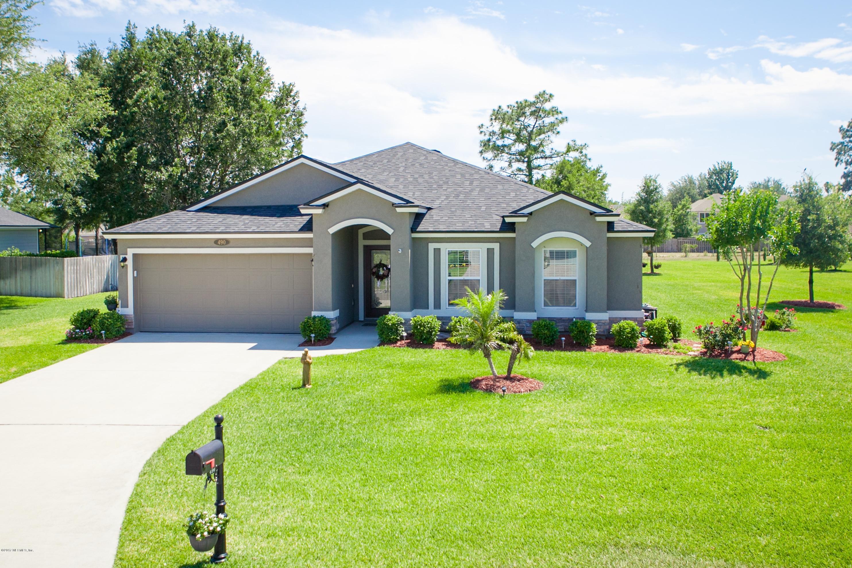 490 Irish Rose Road St. Augustine, FL 32092 - Photo 1 of 44 a front view of house with a garden and porch