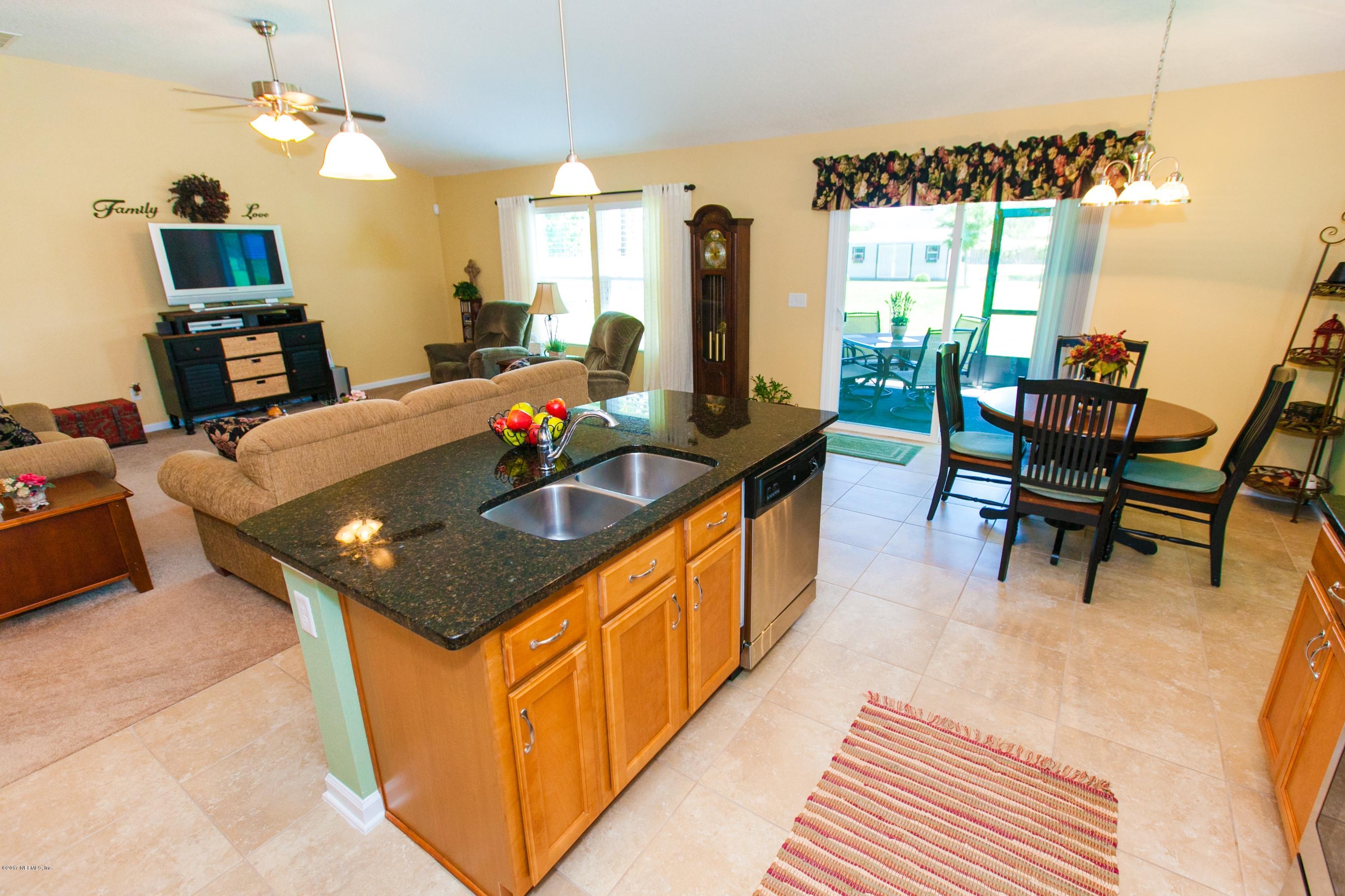 490 Irish Rose Road St. Augustine, FL 32092 - Photo 11 of 44 a kitchen with a sink and a stove top oven