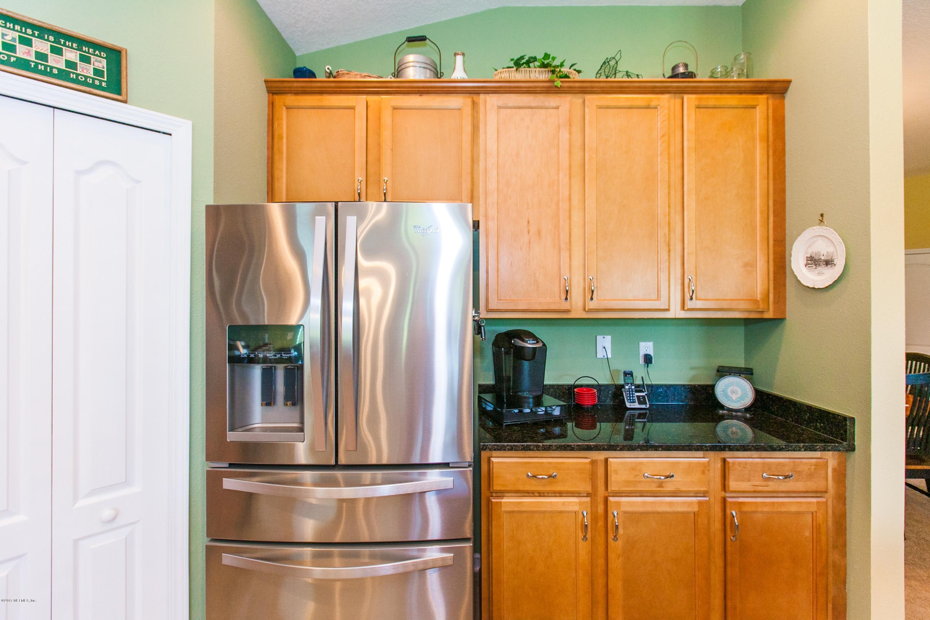 490 Irish Rose Road St. Augustine, FL 32092 - Photo 13 of 44 a kitchen with stainless steel appliances granite countertop a refrigerator and a sink