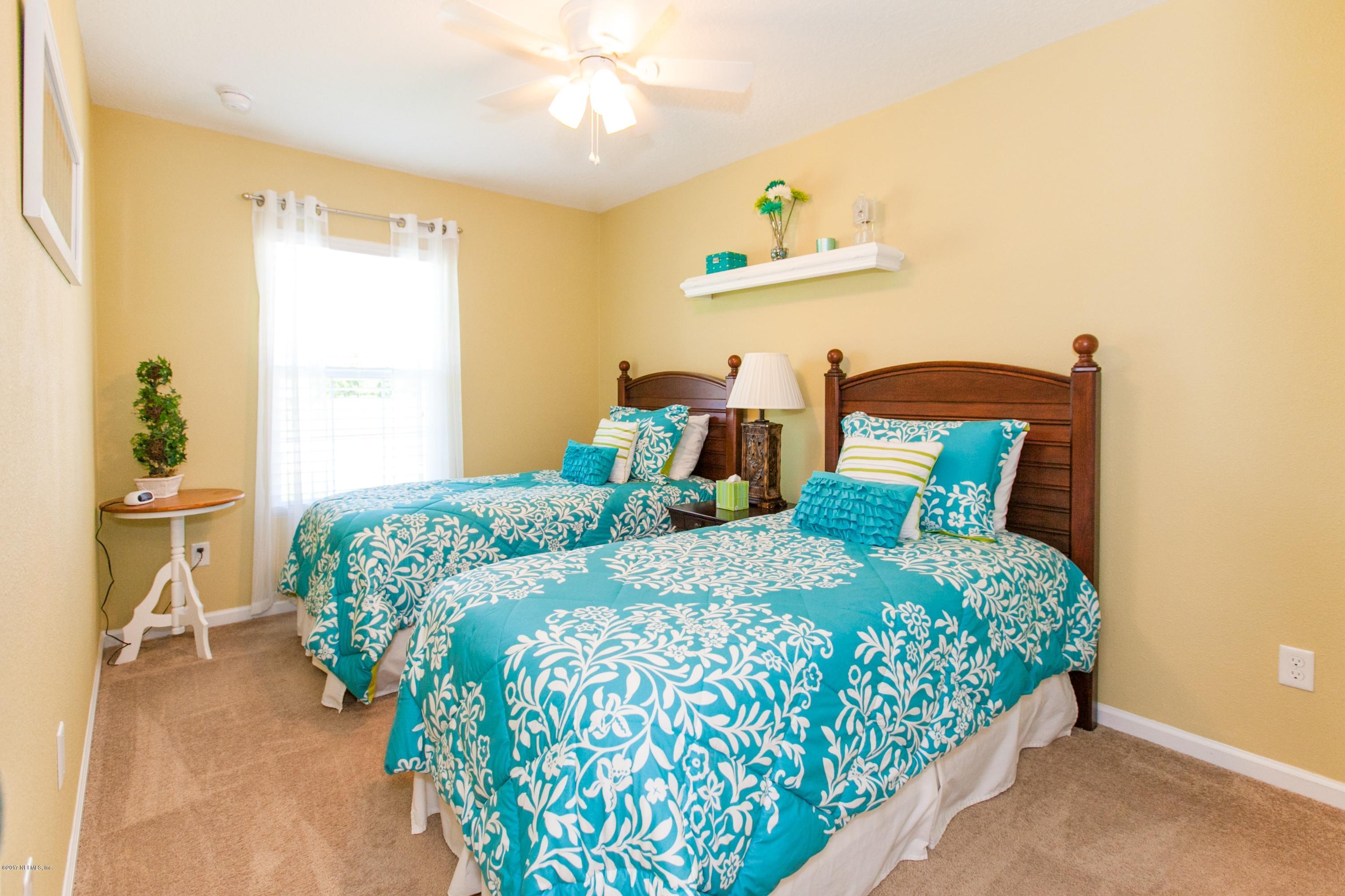 490 Irish Rose Road St. Augustine, FL 32092 - Photo 23 of 44 a bedroom with a bed table and a window