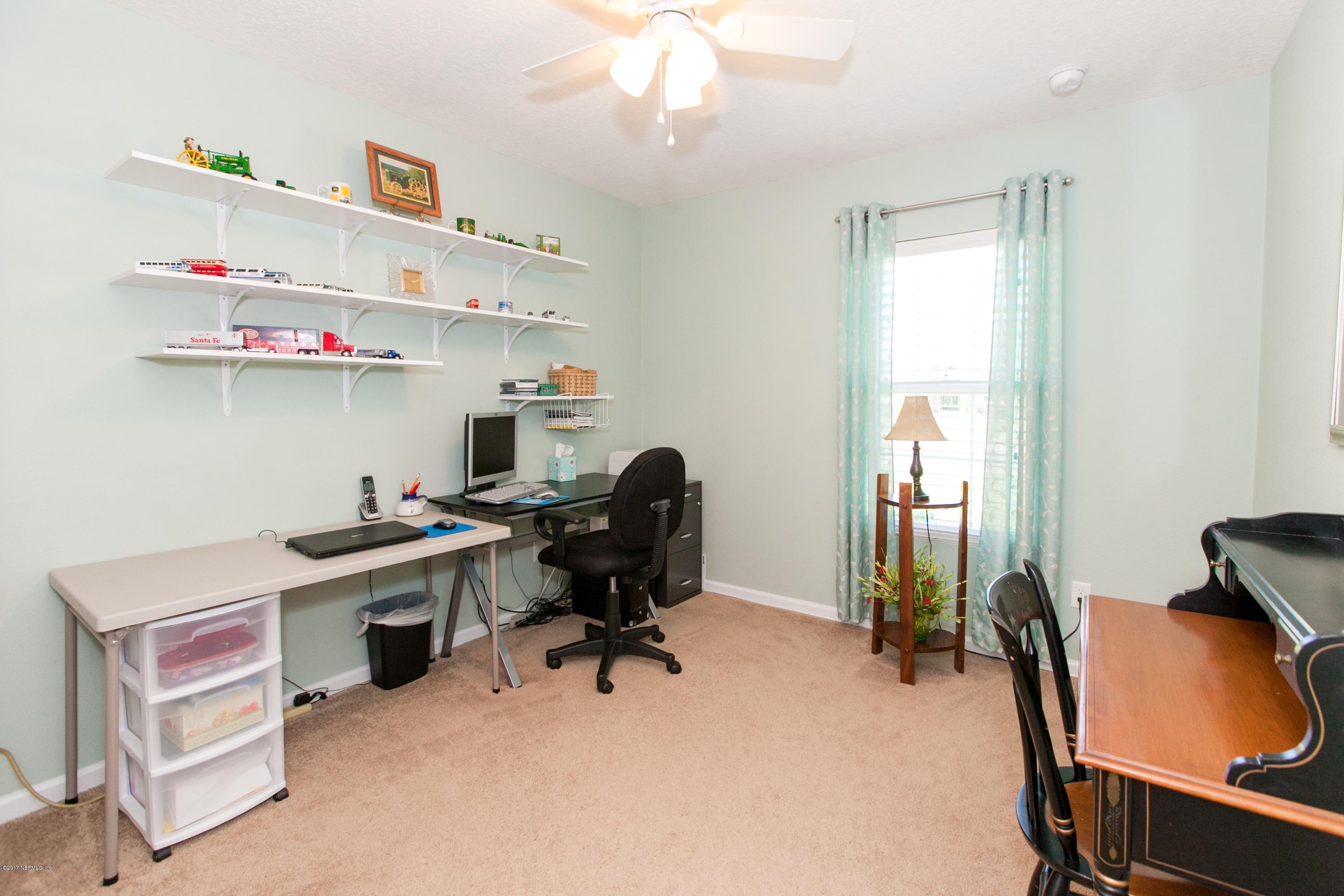 490 Irish Rose Road St. Augustine, FL 32092 - Photo 24 of 44 a view of a workspace with furniture and a window