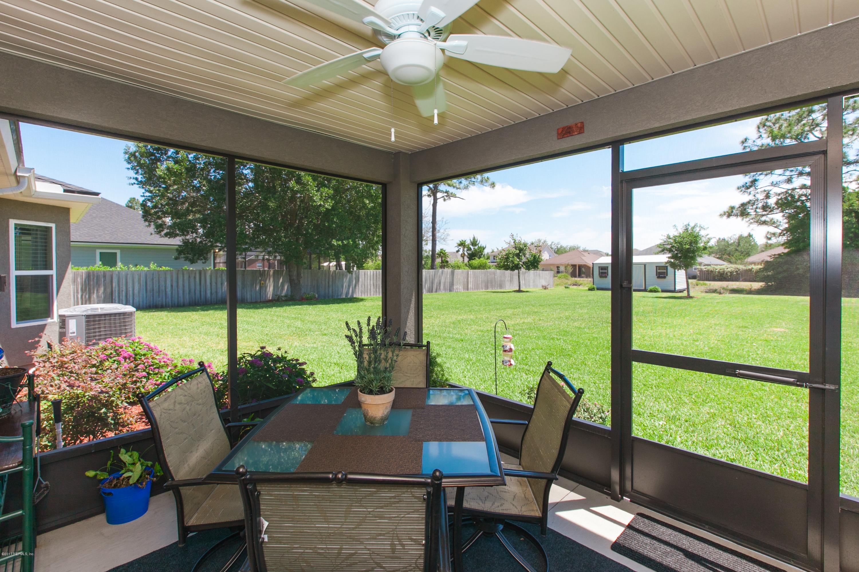 490 Irish Rose Road St. Augustine, FL 32092 - Photo 27 of 44 a view of a porch with furniture and garden