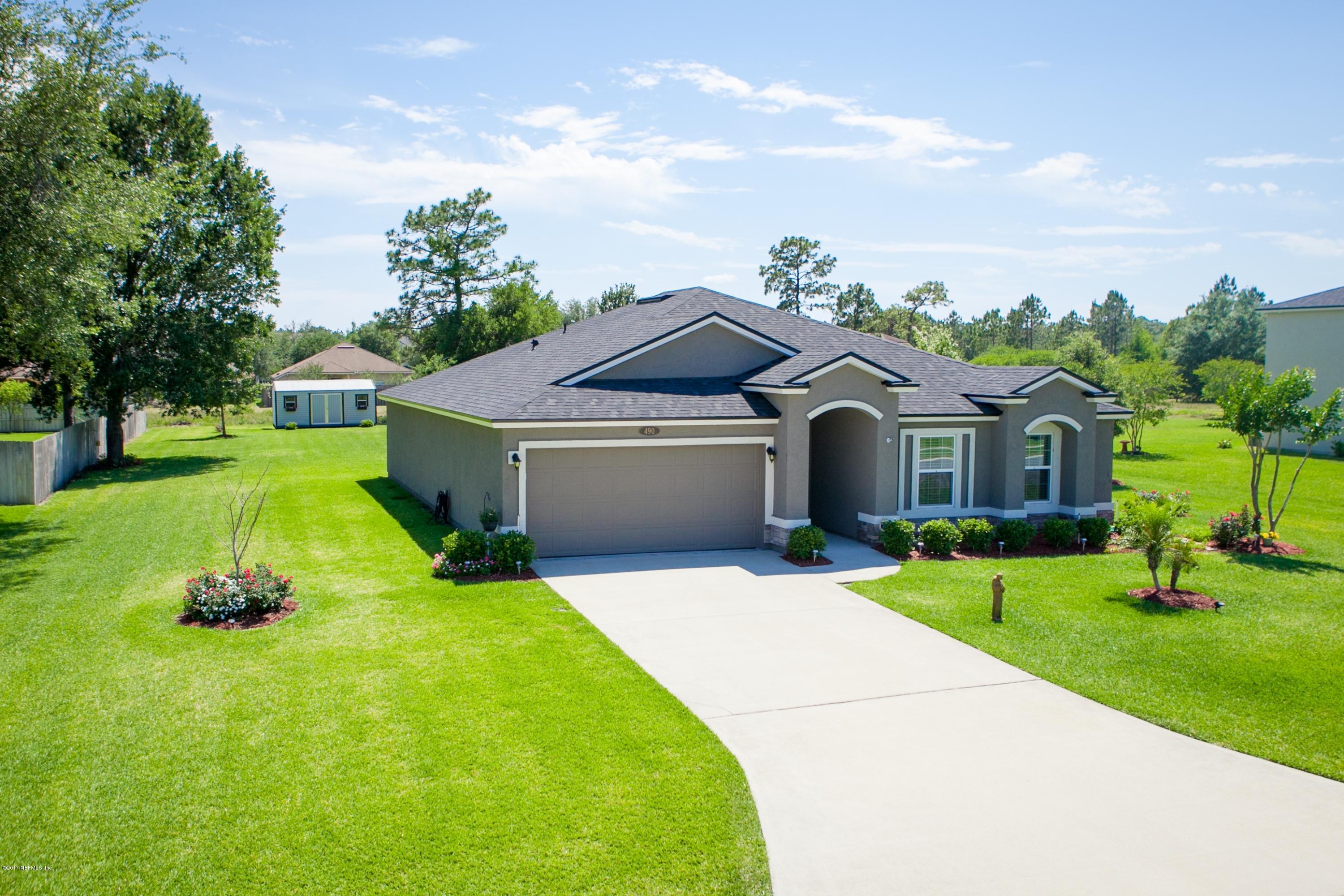 490 Irish Rose Road St. Augustine, FL 32092 - Photo 3 of 44 a front view of a house with garden